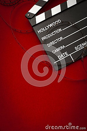 Cinema vintage celluloid filmstrip reel and movie clapper board used in retro film productions and cinematographic events with Stock Photo