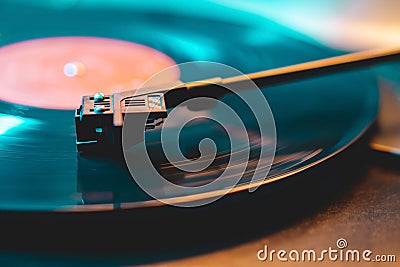 Cinemagraph loop vinyl record player turntable with its stylus running along music plate. Neon light. Retro-styled Stock Photo