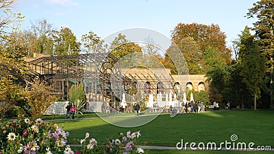 Cinematic Scene With Adults Near Tower Gate Cafe Terrace