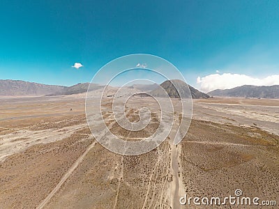 Cinematic shot aerial view of beautiful Mount Bromo volcano with desert in East Java Stock Photo