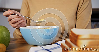 Cinematic slow-motion of woman eating cereal healthy breakfast focus with natural cereals. Peaceful start with healthy Stock Photo