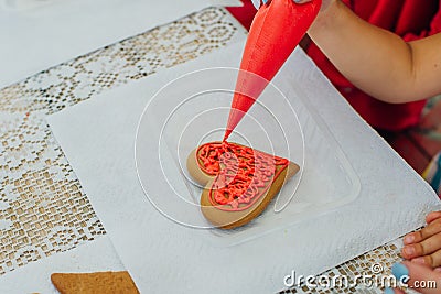 cinnamon cookies icing decorating process with a pastry bag Stock Photo