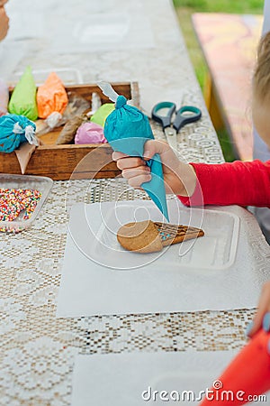 cinnamon cookies icing decorating process with a pastry bag Stock Photo