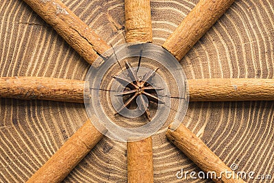 Cinnamon sticks with star anise centred on acacia wood slice Stock Photo