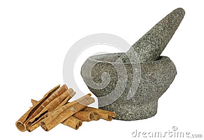 Cinnamon with a stone pounder on white Stock Photo