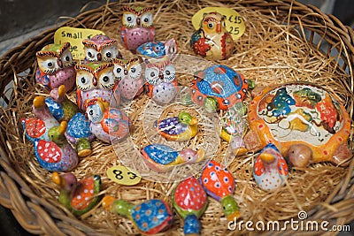 Cinque Terre, Italy - colorful ceramic animal figurines on a basket. Local souvenirs sold in Riomaggiore. Stock Photo