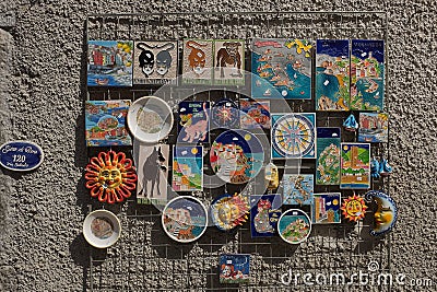 Cinque Terre, Italy - colorful ceramic magnets displayed on a wall. Local souvenirs sold in Riomaggiore. Stock Photo