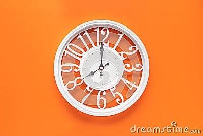 Circle clock on orange background wall Stock Photo
