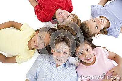 Circle of five young friends smiling Stock Photo
