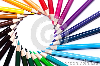 Circle or rainbow swirl of colored pencils on a white background on the left, copy space, mock up, LGBT symbol Stock Photo