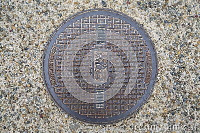 Circle steel manhole cover or metal sewer on the street in Japan Stock Photo