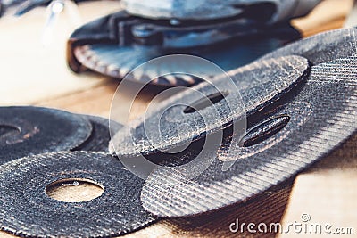 Circles for the angle grinder are on wooden boards near the grinder Stock Photo