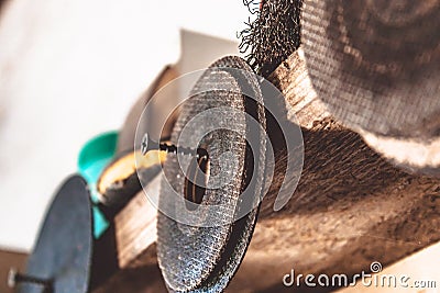 Circles for angle grinders are on wooden shelves. The concept of tools and repair work Stock Photo