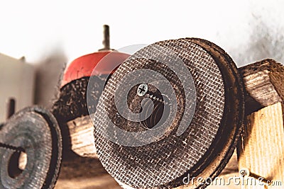 Circles for angle grinders are on wooden shelves. The concept of tools and repair work Stock Photo