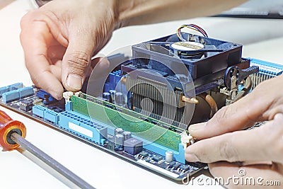 Circuit board computer closeup technician hand using the memory for fixing and upgrade computer pc to repair inside The socket Stock Photo
