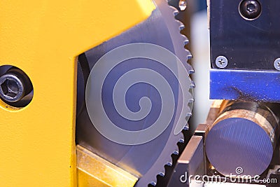 The circular blade saw machine cutting the metal rod. Stock Photo