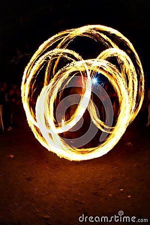 Circular fire trails from a fire juggler Stock Photo