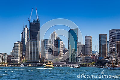 Circular Quay with Ferries and Boats in front of Skyline of Sydney, New South Wales, Australia Stock Photo