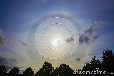 Circular rainbow around the sun. Halo. Stock Photo