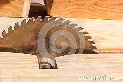 Circular saw blade for cutting wood on old table saw Stock Photo