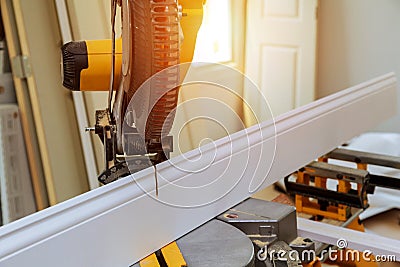 Circular saw cutting wooden base molding blade with board close-up woodworking detail with wood Stock Photo