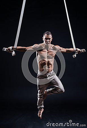 Circus artist on the aerial straps man Stock Photo