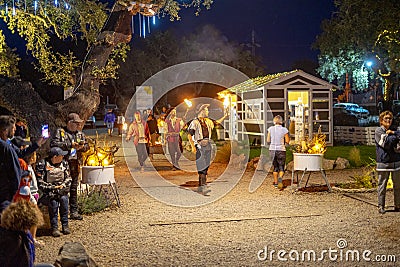 circus arts group juggling fire performing at the black pig theme park distillery in Santiago do Cacém. Editorial Stock Photo