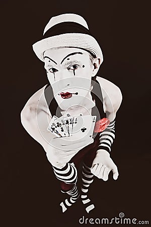 Circus clown in makeup with playing cards Stock Photo