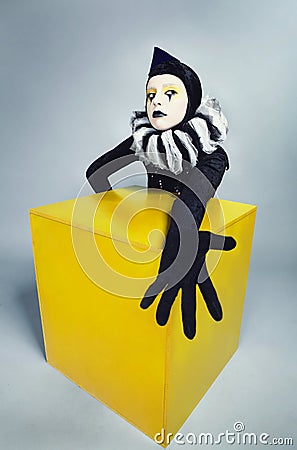 Circus fashion mime posing near a yellow square Stock Photo