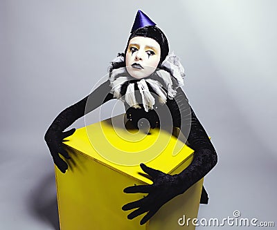 Circus fashion mime posing near a yellow square Stock Photo