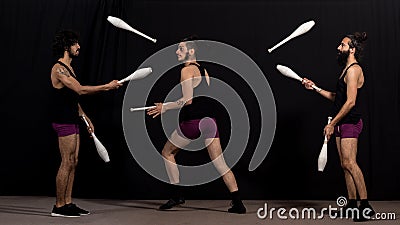 Circus jugglers during their batons performance Stock Photo