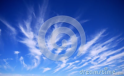 Wispy Clouds Over Deep Blue Sky. Stock Photo