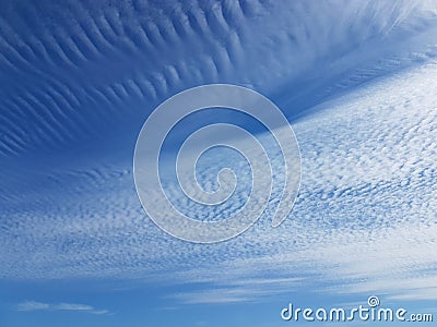 Cirrus clouds on a clear blue sky. Weather forecast. Water in a gaseous state in nature. The atmosphere of the earth. The effect o Stock Photo