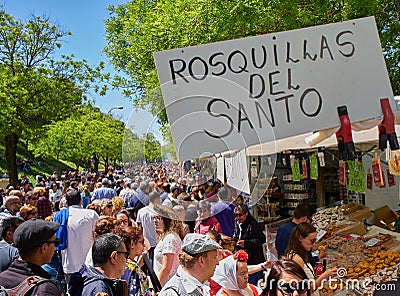 Citizens buying Rosquillas del Santo at the San Isidro fair. Editorial Stock Photo