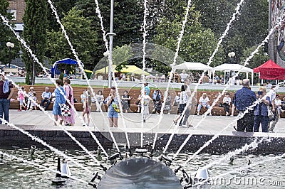 Citizens are resting on the fountain square Editorial Stock Photo