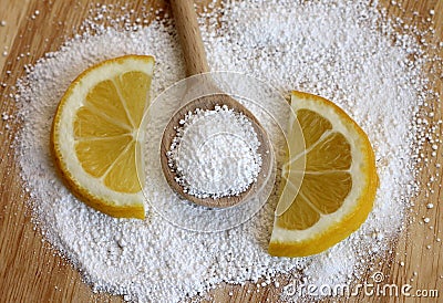 Citric acid in wooden spoon with lemon Stock Photo