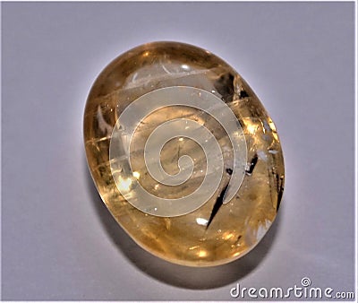 Citrine with rutile inclusions in a cabochon shape Stock Photo