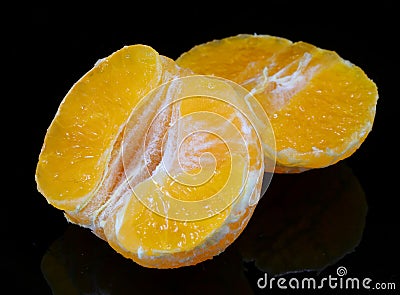 Citrus clementine wedges on a black background Stock Photo