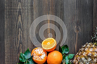 Citrus concept. Oranges, pineapple and mandarins on wooden table background top view copyspace Stock Photo