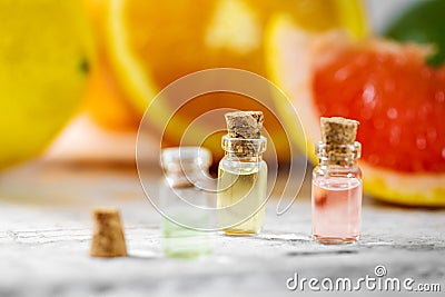 Citrus essential oil bottles on fruit background Stock Photo