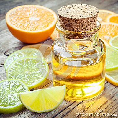 Citrus essential oil and slice of ripe fruits: orange, lemon and Stock Photo