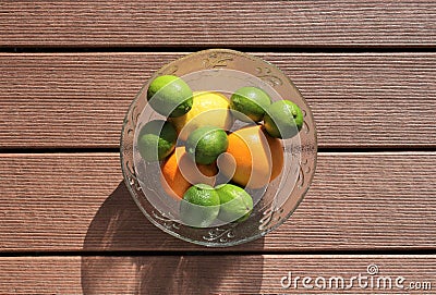 Citrus Fruit in a Clear Bowl, Oranges, Lemons, Limes Stock Photo