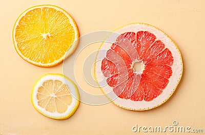 Citrus fruit slices of lemon, orange, grapefruit on yellow background. Stock Photo