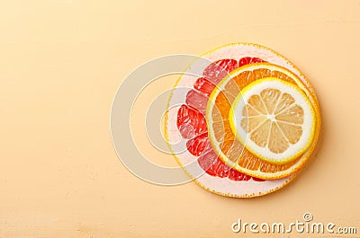 Citrus fruit slices of lemon, orange, grapefruit on yellow background. Stock Photo