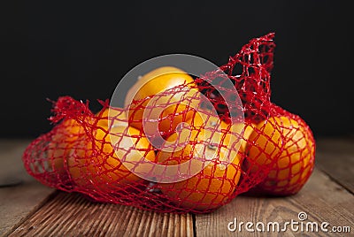 Citrus Fruits Tangerine in Oranges in plastic net bag package. no plastic concept. Packaging that does not recycle. Plastic. Rusti Stock Photo