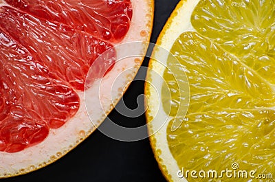 Citrus round slices on black background Stock Photo
