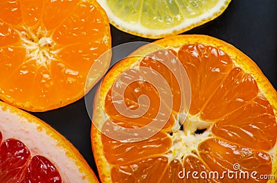 Citrus round slices on black background Stock Photo