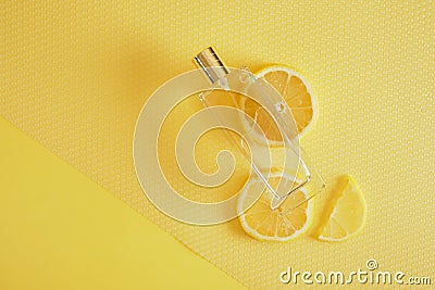Citrus scent, perfume with lemon scent concept, lemon wedges and a bottle of perfume Stock Photo