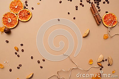 Citrus and spicy background with coffee beans and spices, warm ochre background Stock Photo