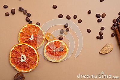 Citrus and spicy background with coffee beans and spices, warm ochre background Stock Photo